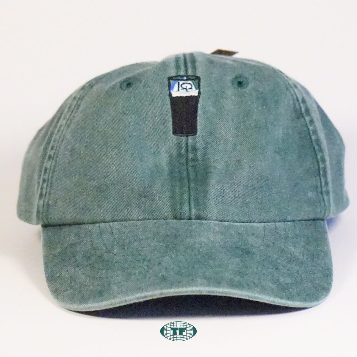Split The G Embroidered cap in green on a white background